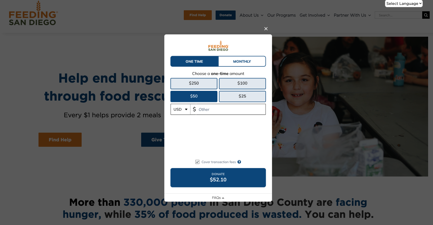 Feeding San Diego donation form open over its website