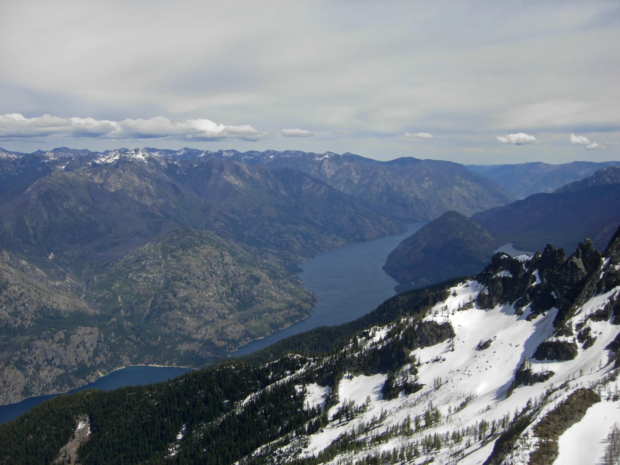 Lake Chelan winding beneath snowy North Cascades peaks, seen from Castle Rock